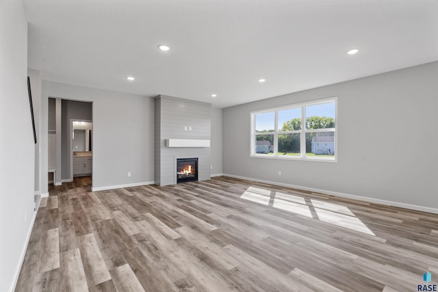 unfurnished living room with light hardwood / wood-style flooring and a fireplace