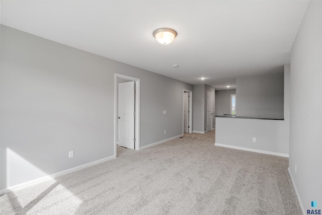 spare room with light colored carpet