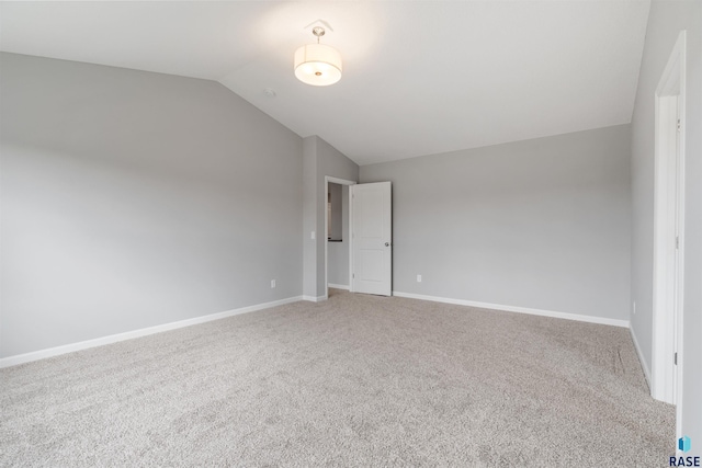 interior space with vaulted ceiling and carpet floors