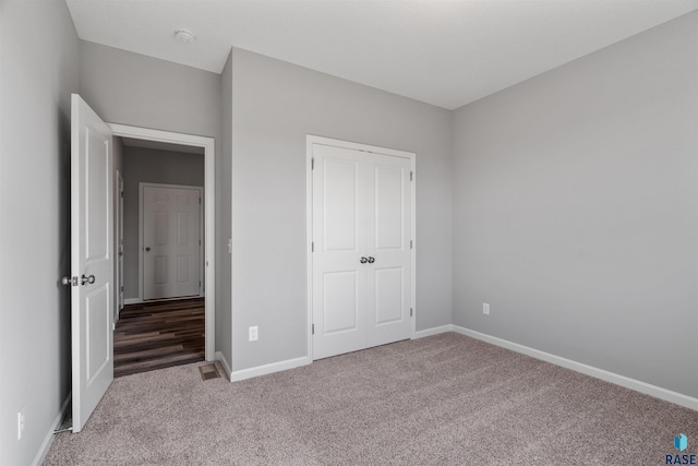 unfurnished bedroom featuring a closet and carpet flooring