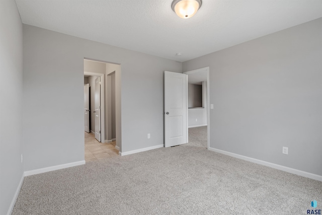 unfurnished bedroom with light colored carpet