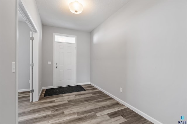 entryway featuring a textured ceiling and hardwood / wood-style flooring