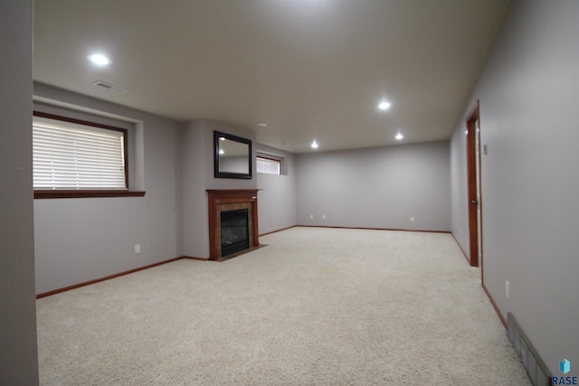 unfurnished living room with light carpet and a fireplace