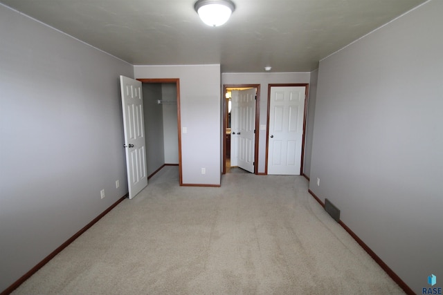 bedroom featuring a closet and light colored carpet