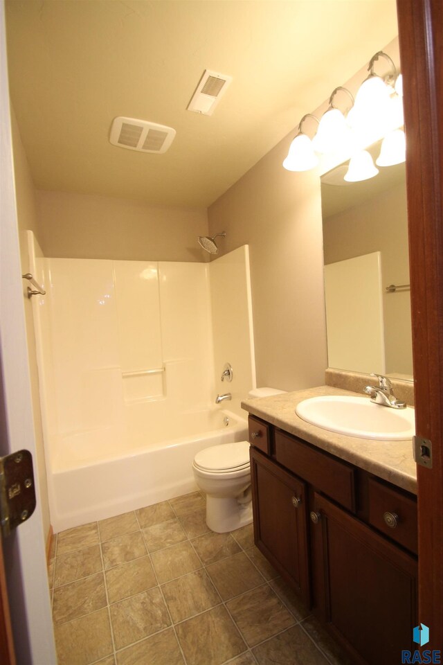 full bathroom with vanity, toilet, tile patterned flooring, and shower / bathtub combination