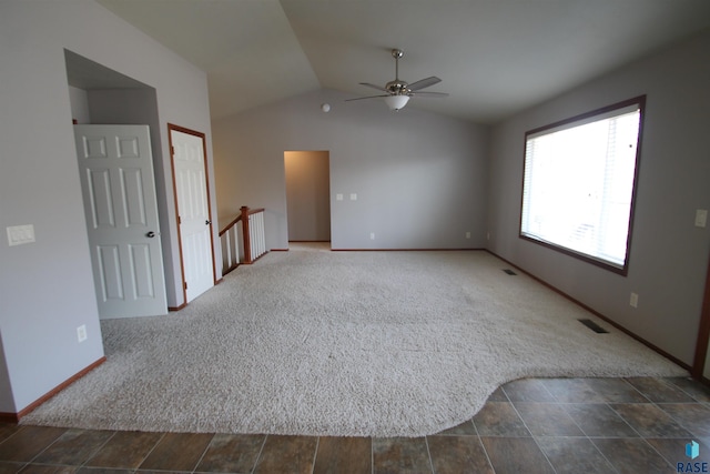 unfurnished room featuring ceiling fan, lofted ceiling, and dark colored carpet