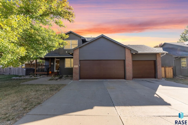 view of front of property with a yard and a garage