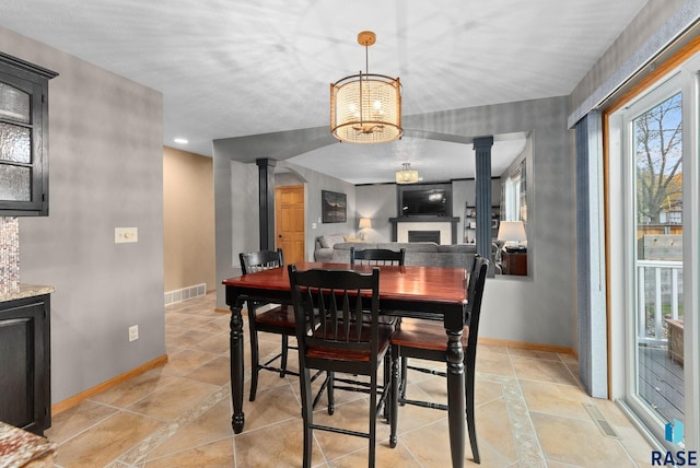 dining room featuring ornate columns