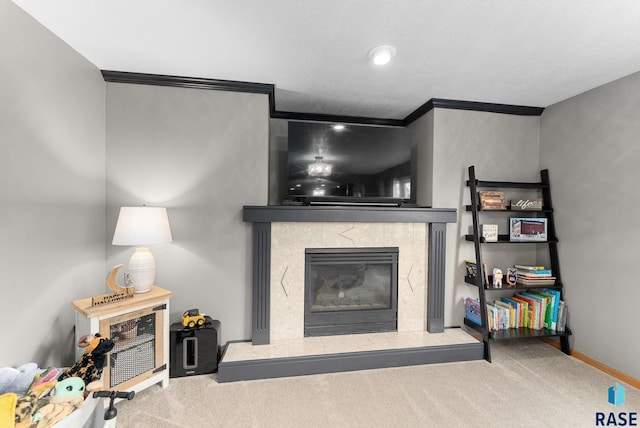 carpeted living room with crown molding and a tile fireplace