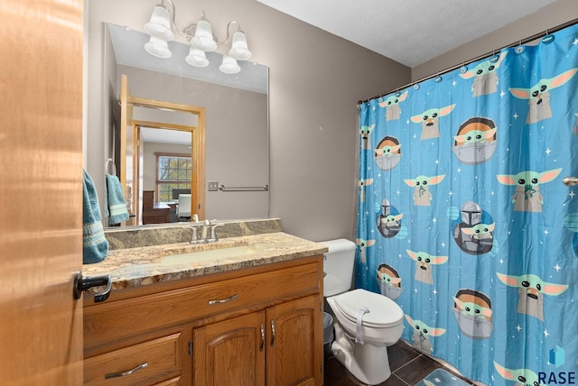 bathroom featuring a textured ceiling, toilet, vanity, a shower with shower curtain, and tile patterned flooring