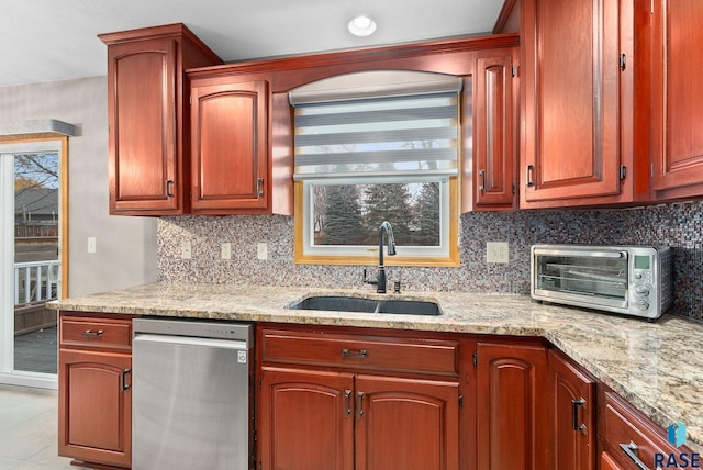 kitchen with sink, light stone countertops, backsplash, and light tile patterned floors