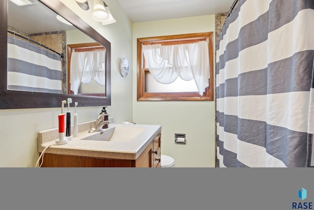 bathroom featuring vanity, toilet, and a shower with shower curtain