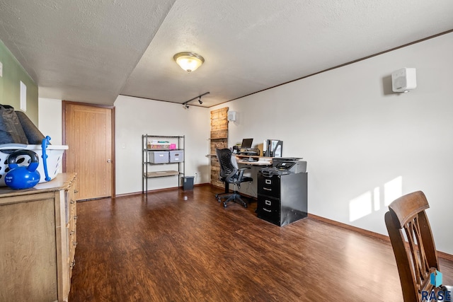 home office featuring track lighting, a textured ceiling, and dark hardwood / wood-style floors