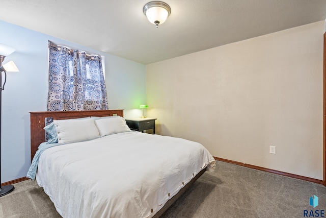 bedroom featuring dark colored carpet