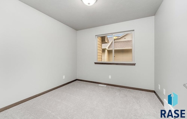 empty room featuring light carpet