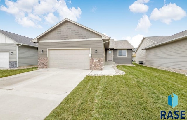 view of front of home with a front yard, a garage, and central air condition unit