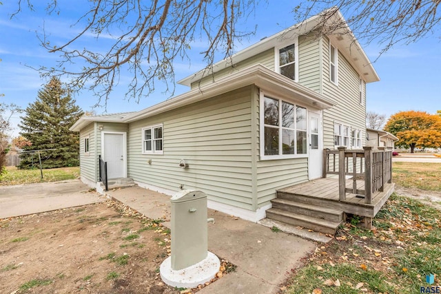 exterior space with a wooden deck and a patio area