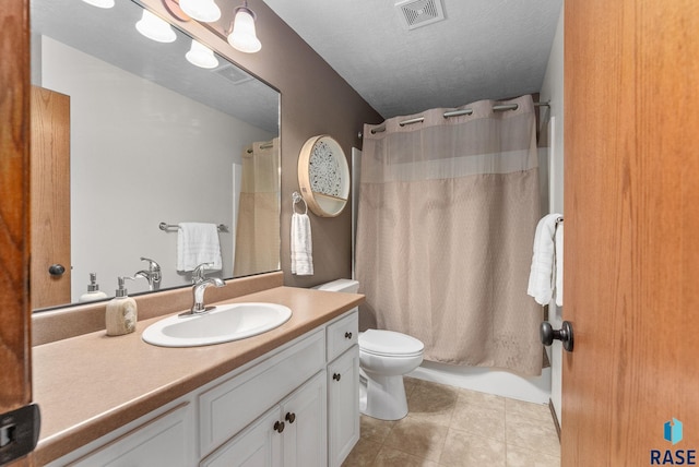 full bathroom with a textured ceiling, toilet, shower / bath combo, vanity, and tile patterned flooring