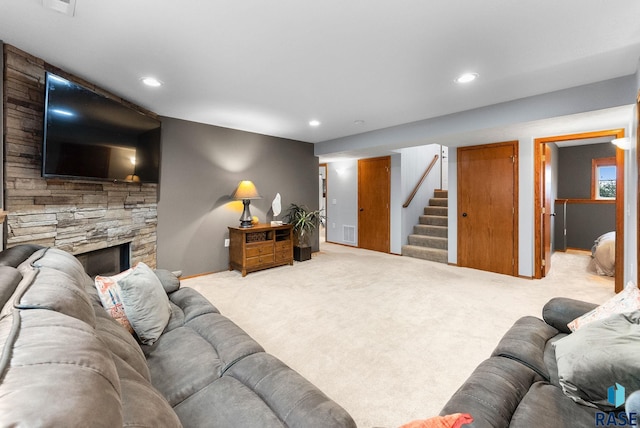 living room with light carpet and a fireplace