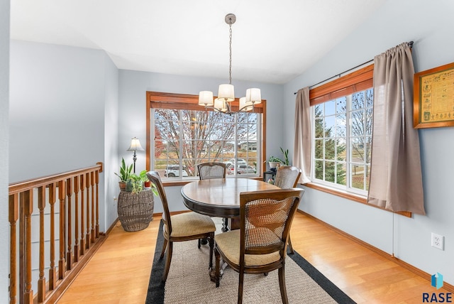 dining area with a notable chandelier and light wood-type flooring