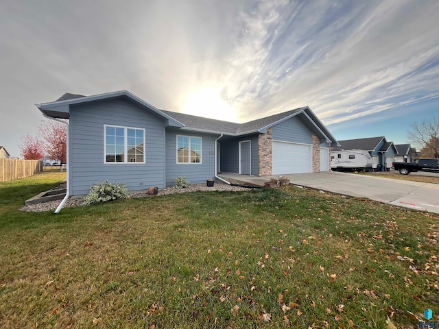 single story home with a front yard and a garage