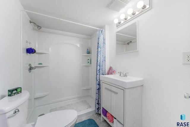 bathroom with vanity, toilet, and walk in shower