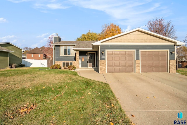 view of front facade with a front yard and a garage