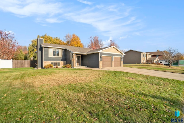 view of front of house with a front yard and a garage