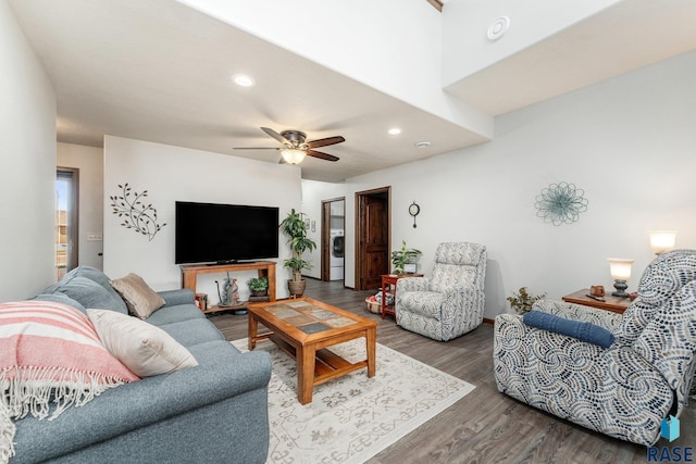 living room featuring washer / dryer, ceiling fan, and hardwood / wood-style flooring