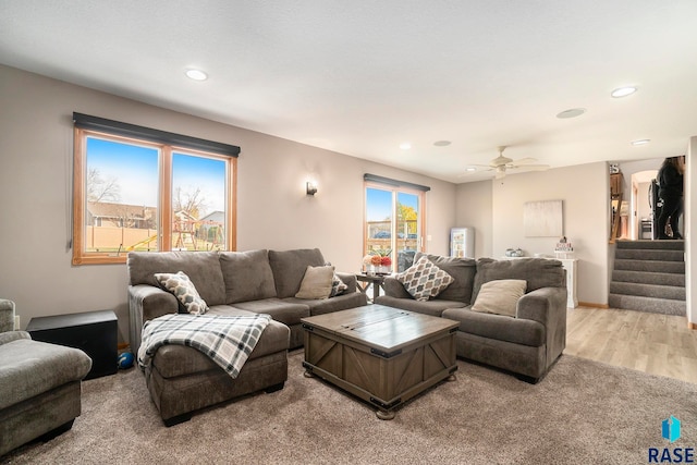 living room featuring a healthy amount of sunlight, light wood-type flooring, and ceiling fan