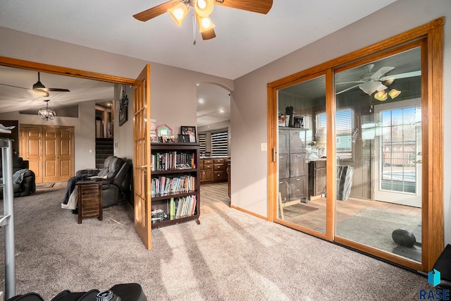 living room with lofted ceiling, light carpet, and ceiling fan