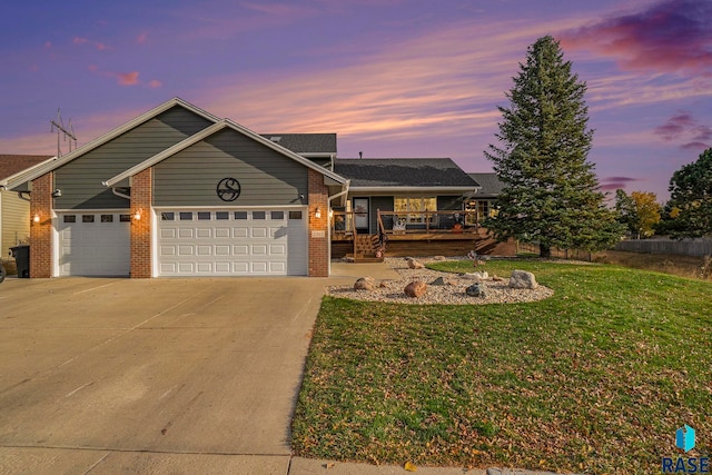 view of front of house with a yard, a garage, and covered porch