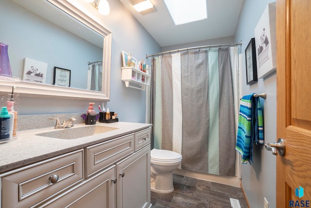 bathroom featuring wood-type flooring, a skylight, toilet, walk in shower, and vanity