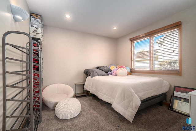 bedroom with dark colored carpet