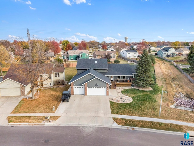 view of front of property with a front yard and a garage