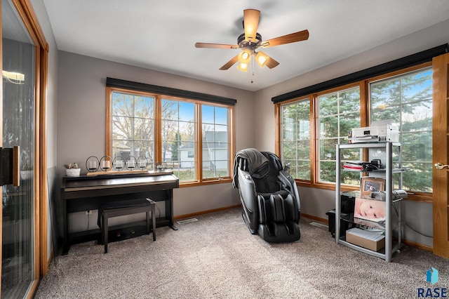 interior space featuring ceiling fan and light colored carpet