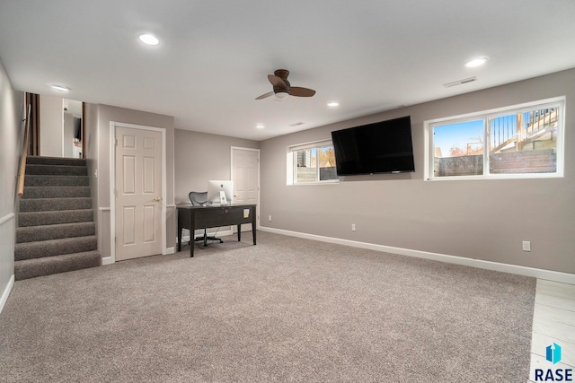 carpeted home office with ceiling fan