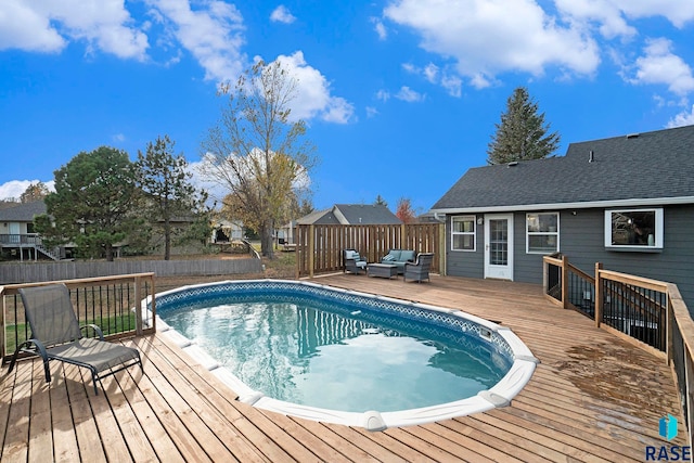 view of swimming pool with a deck