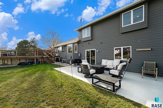 back of house featuring outdoor lounge area, a yard, a deck, and a patio area