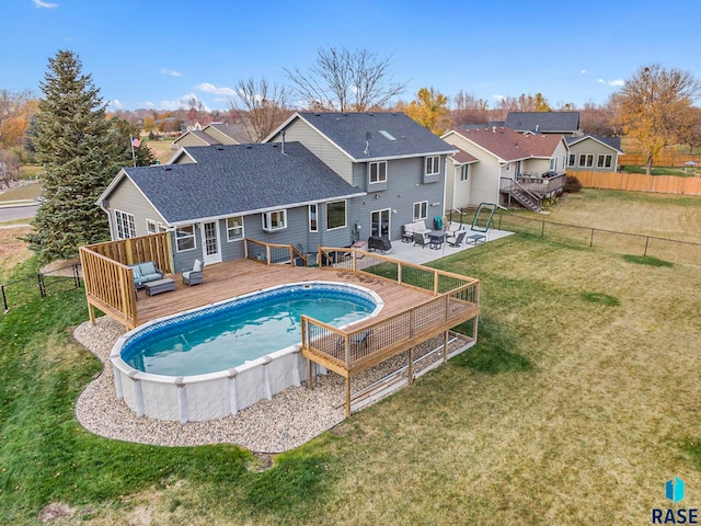 view of pool featuring a yard, a deck, and a patio