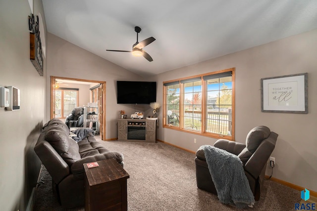 carpeted living room with ceiling fan, lofted ceiling, and a fireplace