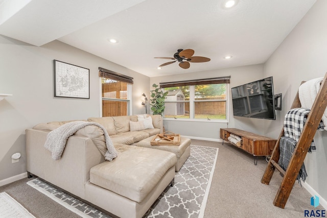 living room featuring carpet flooring and ceiling fan