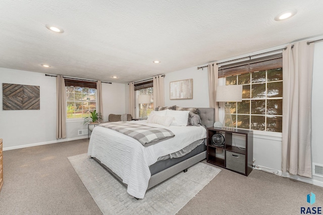 carpeted bedroom with a textured ceiling