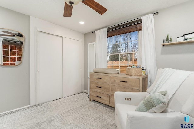 sitting room with light carpet and ceiling fan