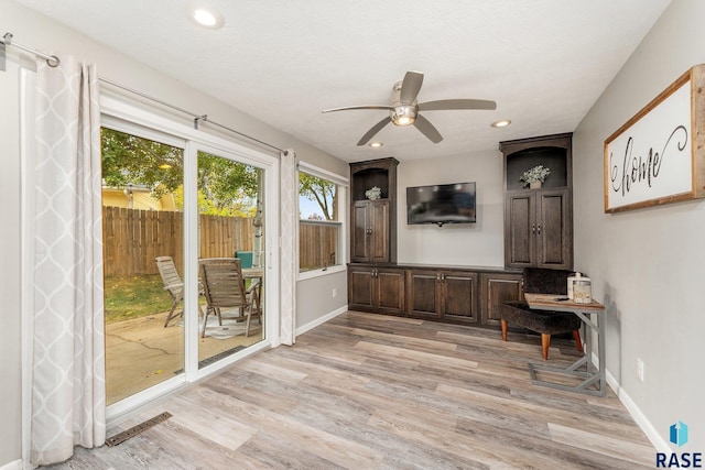 interior space with ceiling fan