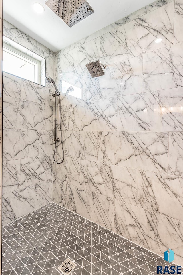 bathroom with a tile shower