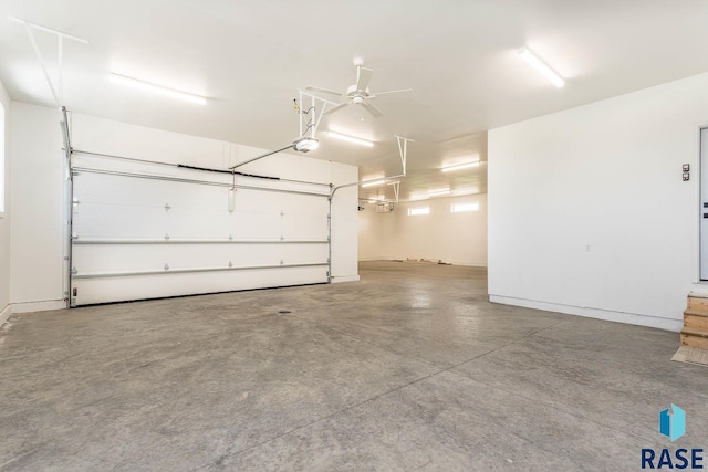 garage featuring ceiling fan and a garage door opener