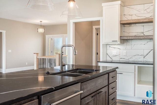 kitchen with dishwasher, backsplash, white cabinets, sink, and hanging light fixtures