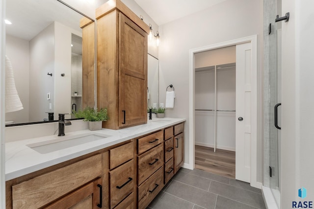 bathroom featuring an enclosed shower, vanity, and tile patterned floors