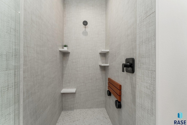 bathroom with tiled shower